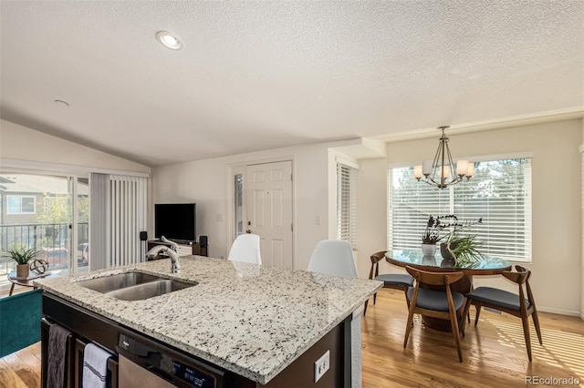 kitchen featuring dishwasher, an island with sink, sink, and a healthy amount of sunlight