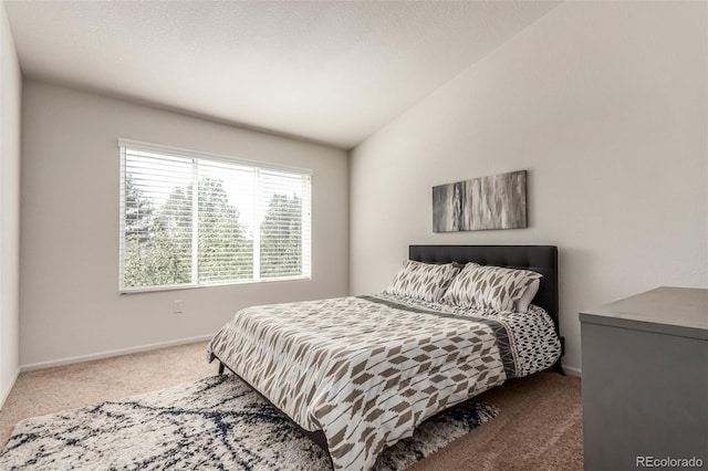 bedroom featuring vaulted ceiling and carpet flooring