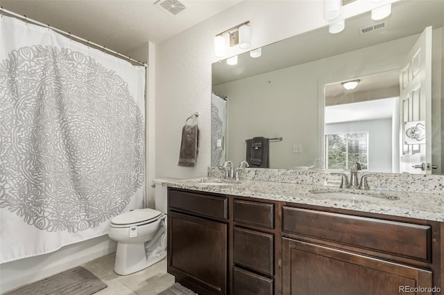 full bathroom featuring tile patterned floors, shower / bath combination with curtain, toilet, and vanity