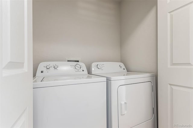 laundry room with washing machine and clothes dryer