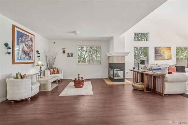 7664 S Ivanhoe Way, Centennial, CO 80112 - living room with healthy amount of natural light, a tiled fireplace, and wood finished floors