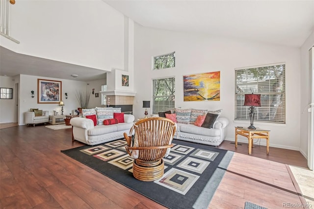 7664 S Ivanhoe Way, Centennial, CO 80112 - living room featuring wood finished floors, a tile fireplace, and high vaulted ceiling