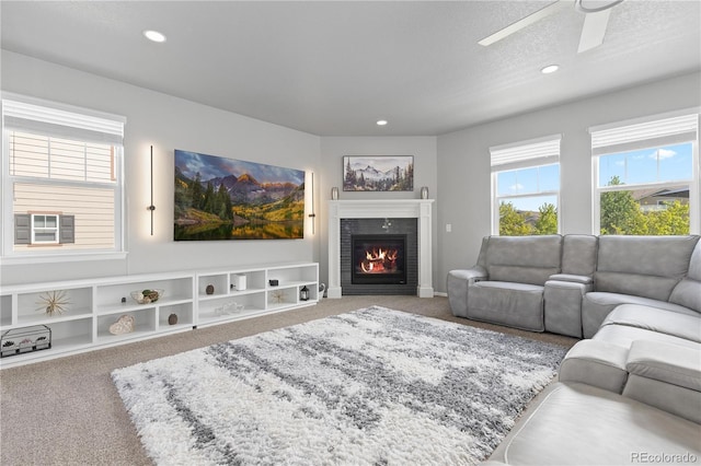 1315 Sidewinder Cir, Castle Rock, CO 80108 - carpeted living room with a ceiling fan, a tiled fireplace, and recessed lighting