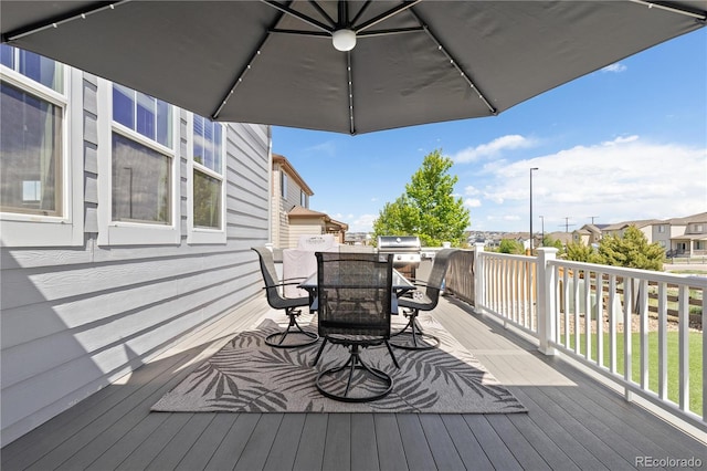 1315 Sidewinder Cir, Castle Rock, CO 80108 - wooden terrace featuring outdoor dining area, grilling area, and a residential view