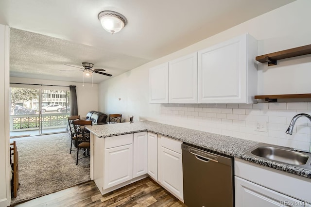 kitchen featuring dishwasher, white cabinetry, dark wood-type flooring, ceiling fan, and decorative backsplash