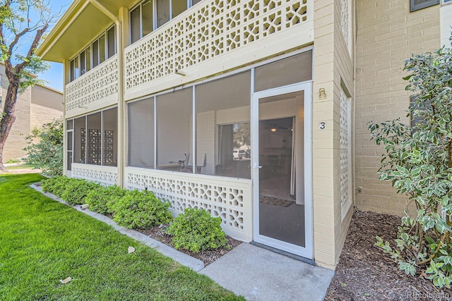 property entrance with a yard