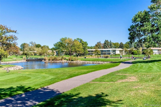 view of home's community featuring a yard and a water view