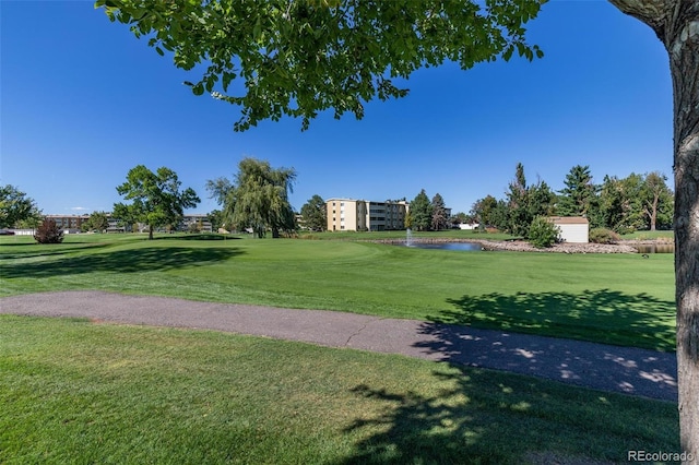 view of home's community featuring a yard and a water view