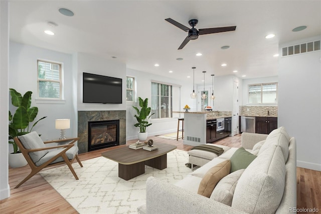 3322 W 26th Ave, Denver, CO 80211 - living room with a fireplace, ceiling fan, light wood finished floors, recessed lighting, and baseboards