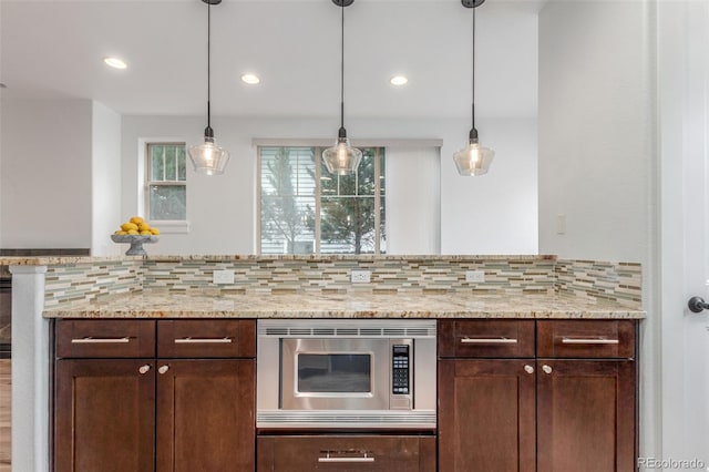 3322 W 26th Ave, Denver, CO 80211 - kitchen featuring stainless steel microwave, healthy amount of natural light, backsplash, dark brown cabinets, and recessed lighting