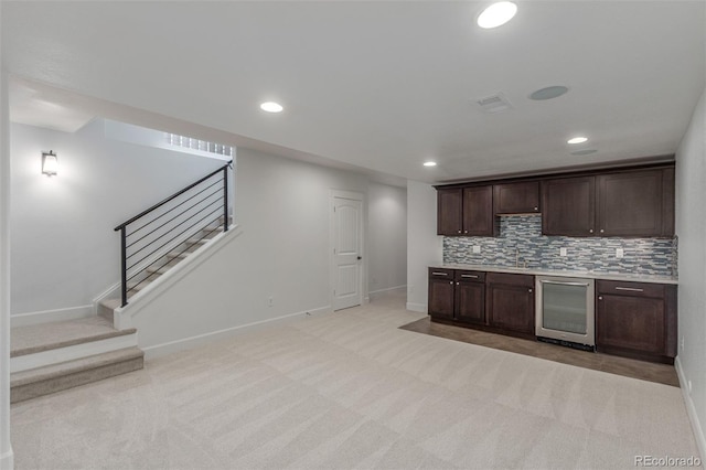 3322 W 26th Ave, Denver, CO 80211 - kitchen with beverage cooler, dark brown cabinets, light colored carpet, baseboards, and recessed lighting
