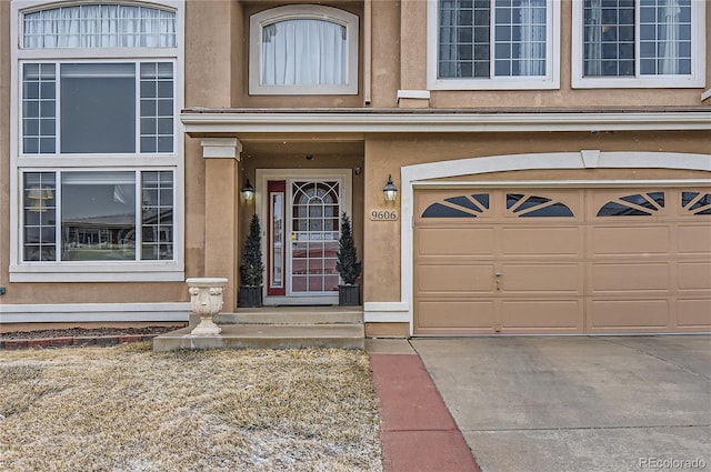 view of exterior entry with a garage