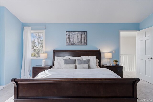 bedroom with baseboards and carpet