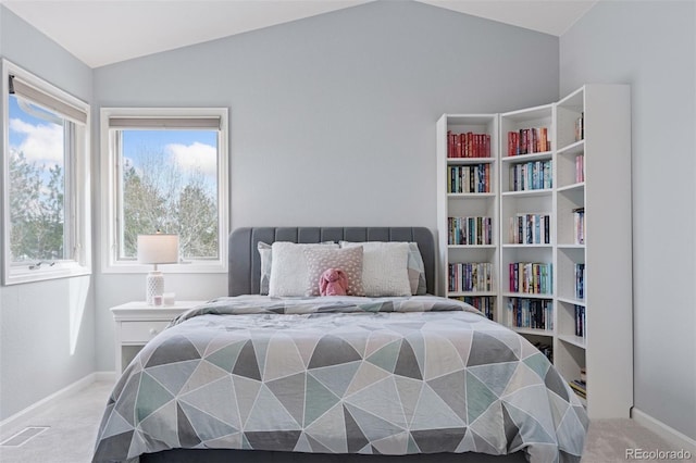 carpeted bedroom with vaulted ceiling, visible vents, and baseboards