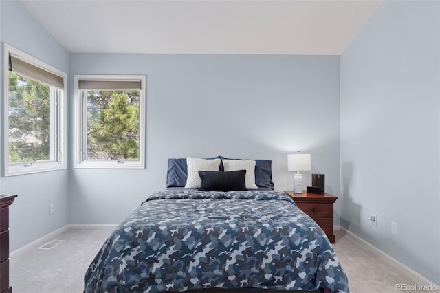 carpeted bedroom with baseboards and visible vents