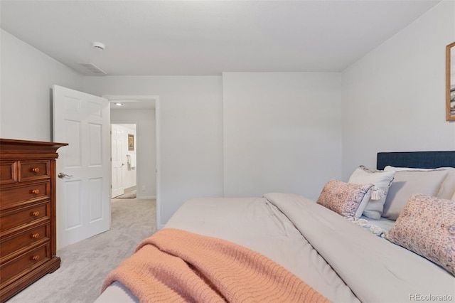 bedroom featuring light carpet and visible vents