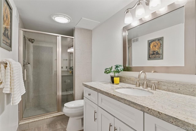 full bath featuring toilet, vanity, visible vents, and a stall shower