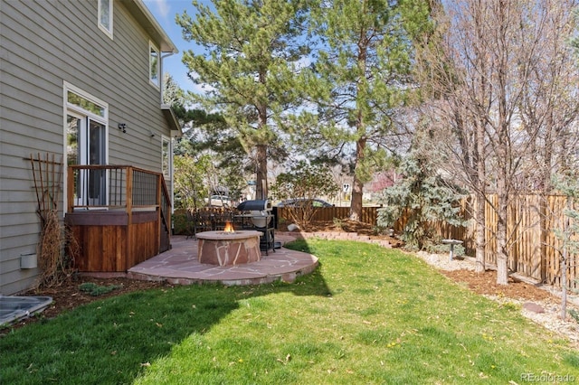 view of yard with a fenced backyard, a patio area, and an outdoor fire pit