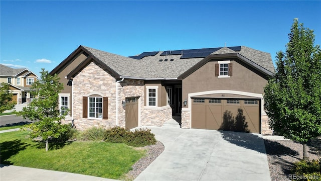 view of front of home featuring a front yard and solar panels