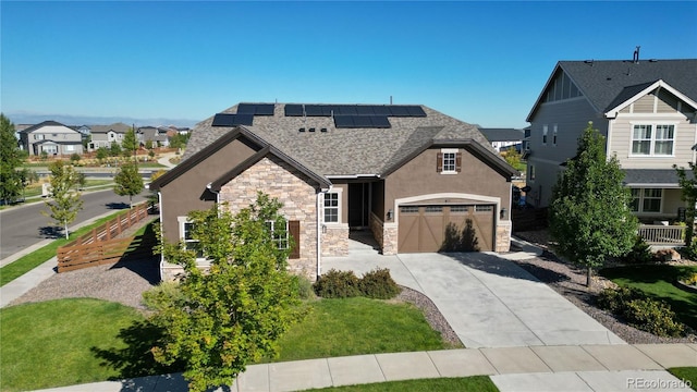 view of front of house featuring solar panels and a garage