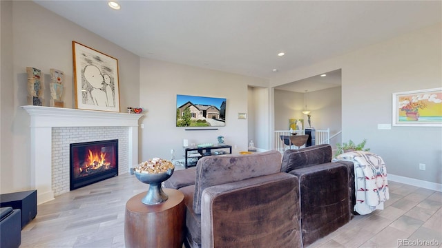 living room featuring light hardwood / wood-style flooring and a fireplace