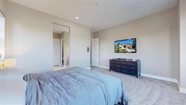 bedroom featuring light carpet