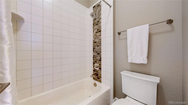 bathroom featuring toilet and shower / bathtub combination with curtain