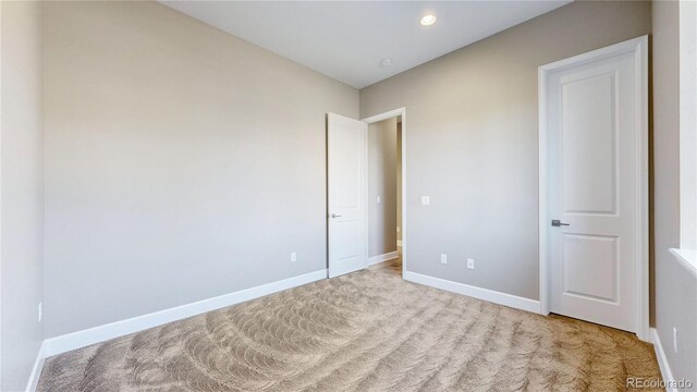 unfurnished bedroom with light colored carpet