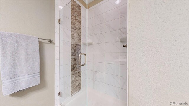 bathroom with a shower with shower door