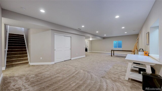 basement featuring light carpet