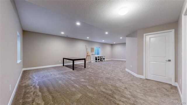 interior space featuring a textured ceiling and carpet