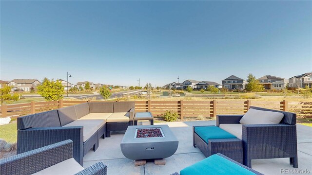 view of patio / terrace featuring an outdoor living space with a fire pit