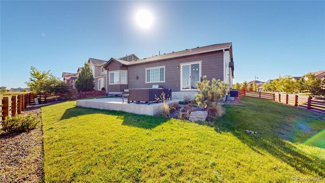 back of house with a yard, a patio, and central AC