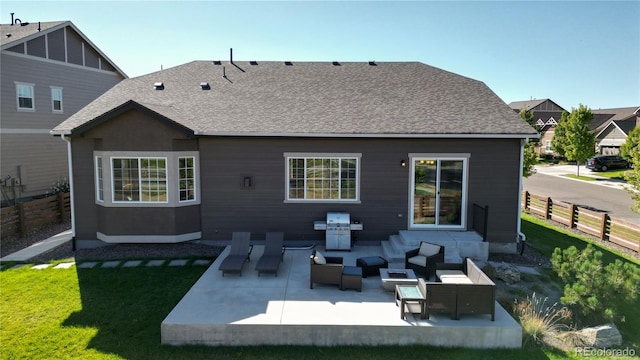 rear view of house with a yard, a patio area, and an outdoor hangout area