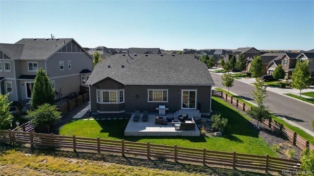 back of house with a lawn