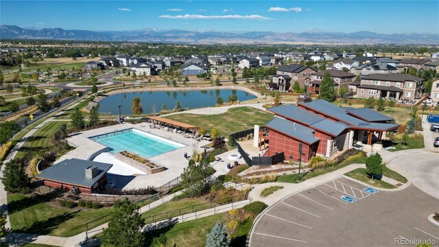 birds eye view of property featuring a water and mountain view