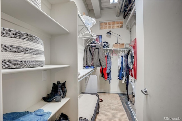 walk in closet featuring stacked washer / drying machine