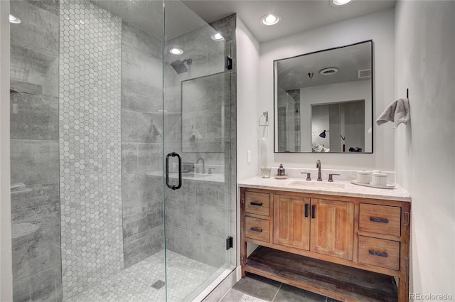 full bath featuring tile patterned flooring, recessed lighting, visible vents, vanity, and a shower stall