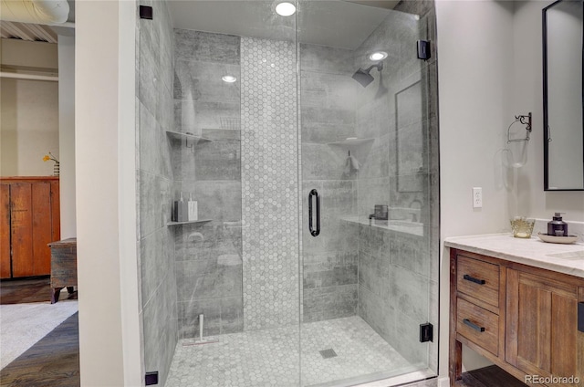 bathroom featuring a stall shower and vanity