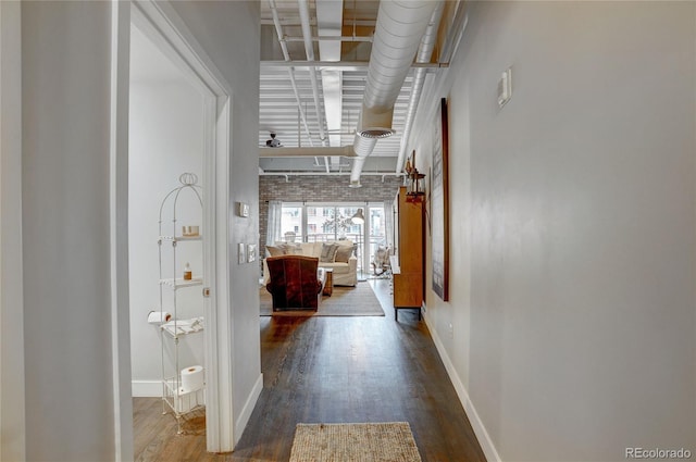 hallway with wood finished floors and baseboards