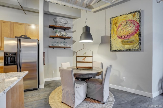 dining room featuring baseboards and dark wood-style flooring