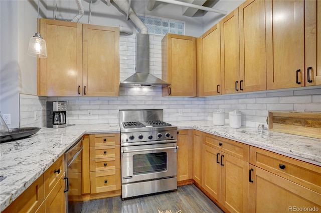 kitchen with decorative backsplash, dark wood-style flooring, light stone countertops, high end stove, and wall chimney range hood