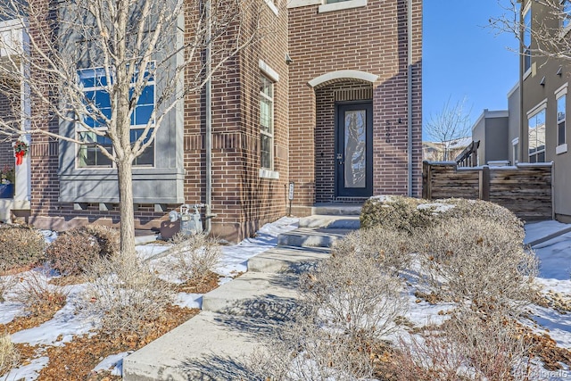 view of snow covered property entrance