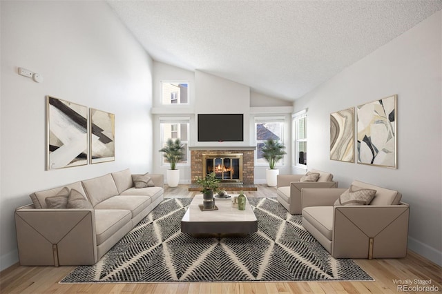 living room with a towering ceiling, hardwood / wood-style floors, and a textured ceiling