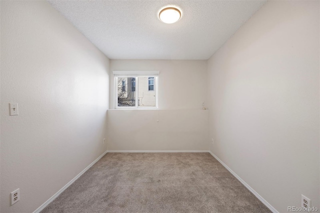 carpeted spare room with a textured ceiling