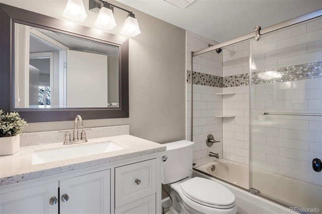 full bathroom featuring vanity, bath / shower combo with glass door, and toilet