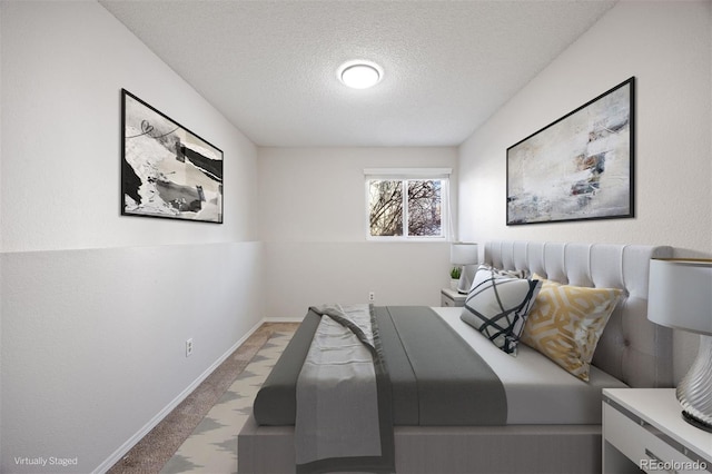 carpeted bedroom featuring a textured ceiling