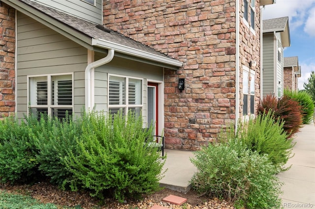 2511 S Bahama Cir Unit A, Aurora, CO 80013 - entrance to property with a shingled roof and brick siding