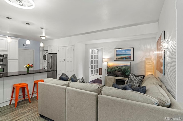 2511 S Bahama Cir Unit A, Aurora, CO 80013 - living area with stacked washer and clothes dryer and wood finished floors