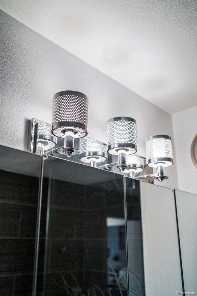 2511 S Bahama Cir Unit A, Aurora, CO 80013 - bathroom view of a textured wall and a chandelier
